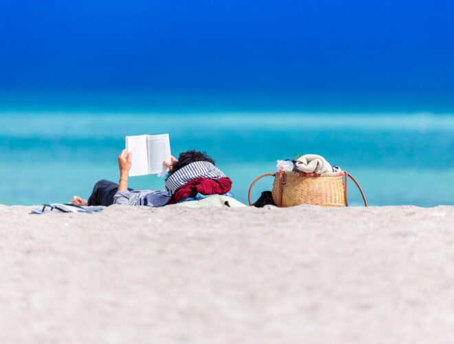 beach lounger with a book in hand